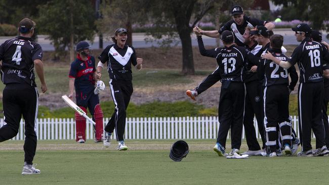 Adelaide University celebrate after winning the Twenty20 grand final, beating East Torrens. Picture: AAP/Emma Brasier