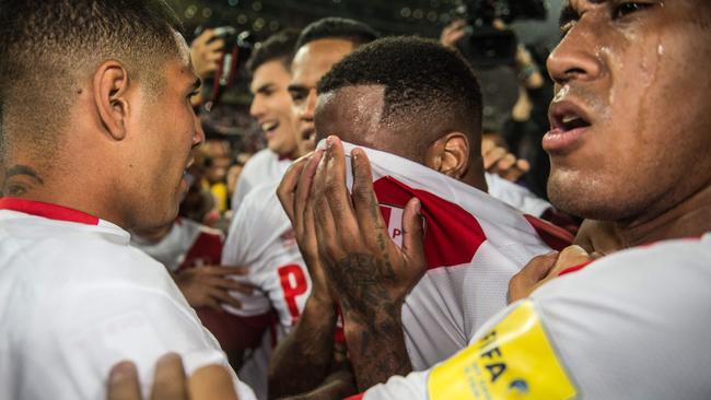 Peru's Jefferson Farfan (C) cries after defeating New Zealand.