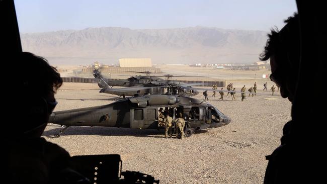 Australian Army Special Operations Task Group soldiers land in a US Army Black Hawk helicopter at Tarin Kowt after a 'shura' (town meeting) in Shah Wali Kot in Kandahar province, Afghanistan. *** Local Caption *** Australian Army soldiers from Special Operations Task Group (SOTG) and Afghan National Security Force police officers conducted a deliberate operation to clear a Taliban insurgent stronghold in the Shah Wali Kot region of northern Kandahar province in Afghanistan.  The Shah Wali Kot Offensive comprised synchronised and deliberate clearance operations involving Australian commandos combined with a number of surgical helicopter-born assaults from Special Air Service Regiment (SASR) soldiers onto key targets.  Removing Taliban insurgents from Afghan communities allows the Afghan government to gain the trust of the community and provide vital infrastructure, services and security.  The Shah Wali Kot Offensive was part of Australiaâs contribution to Operation Hamkari, the coalition operation to extend the Afghan governmentâs influence into Kandahar City.  SOTG comprises personnel from the Special Air Service Regiment, 1st and 2nd Commando Regiments, Incident Response Regiment, Special Operations Logistics Squadron and a variety of supporting units from the ADF. Picture: Department of Defence