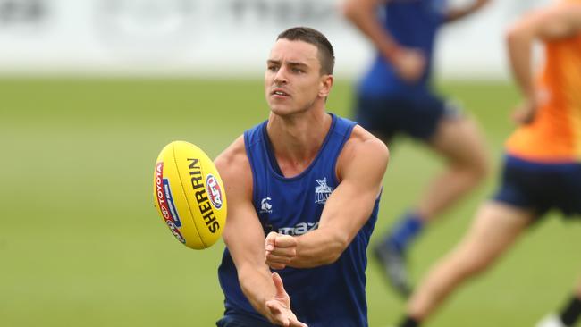 MELBOURNE, AUSTRALIA - JANUARY 18: Luke Davies-Uniacke of the Kangaroos handballs during a North Melbourne Kangaroos AFL training session at Arden Street Ground on January 18, 2021 in Melbourne, Australia. (Photo by Mike Owen/Getty Images)