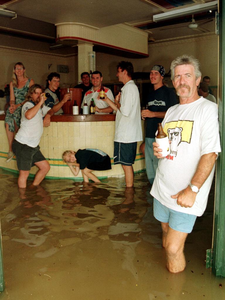 Gympie locals weren't prepared to let a bit of flooding get between them and a coldy at the local pub on Februay 9, 1999. Photo: Grainger/Laffan
