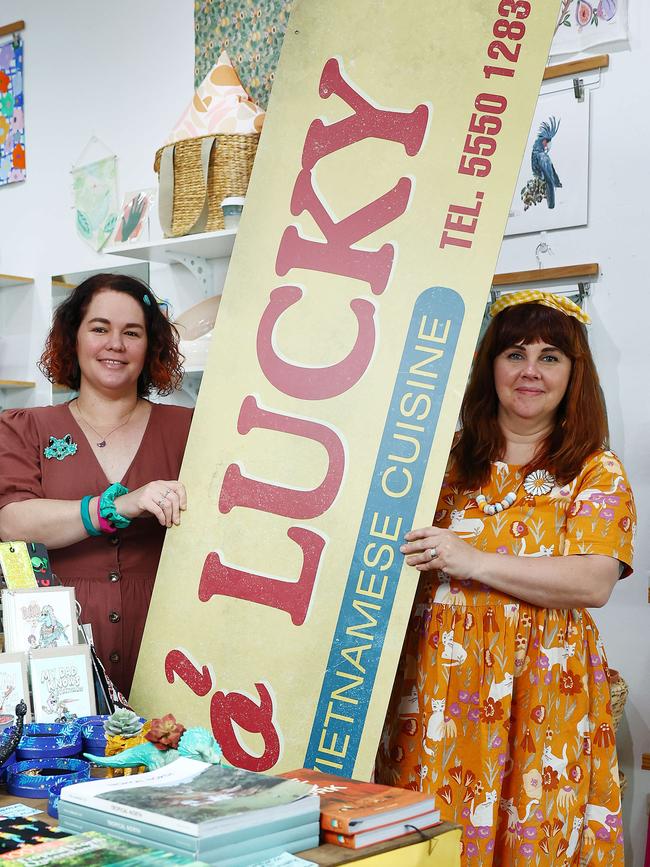 Makin' Whoopee co owners Kirsty Mulley and Fany Saumure hold the prop sign that hung above their shop during filming. Picture: Brendan Radke