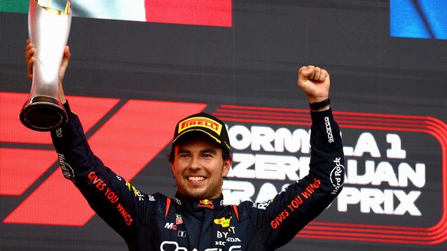 Race winner Sergio Perez of Mexico Red Bull Racing celebrates on the podium