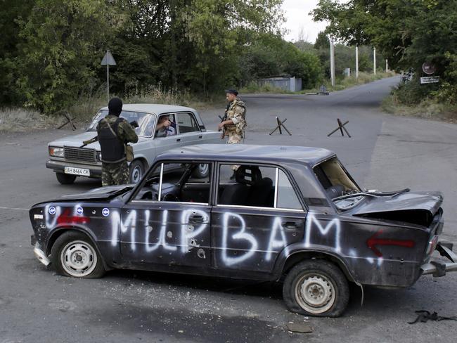 Ukrainian troops stop a car at a checkpoint in the eastern city of Debaltseve. AFP PHOTO/ ANATOLII STEPANOV