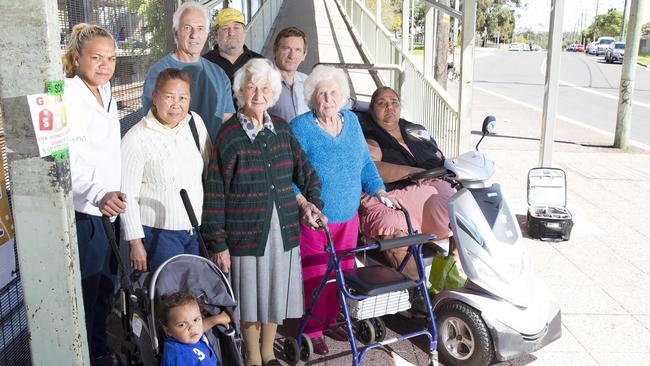 Warren Hardy (yellow cap) and Blacktown Mayor Stephen Bali (back row, right) with commuters at Doonside train station.