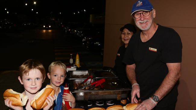 Alex, 7, and Nate Whitfield, 6, of Glenhaven refuel with a barbecue served by Quinn Huynh and Graham Rowe.