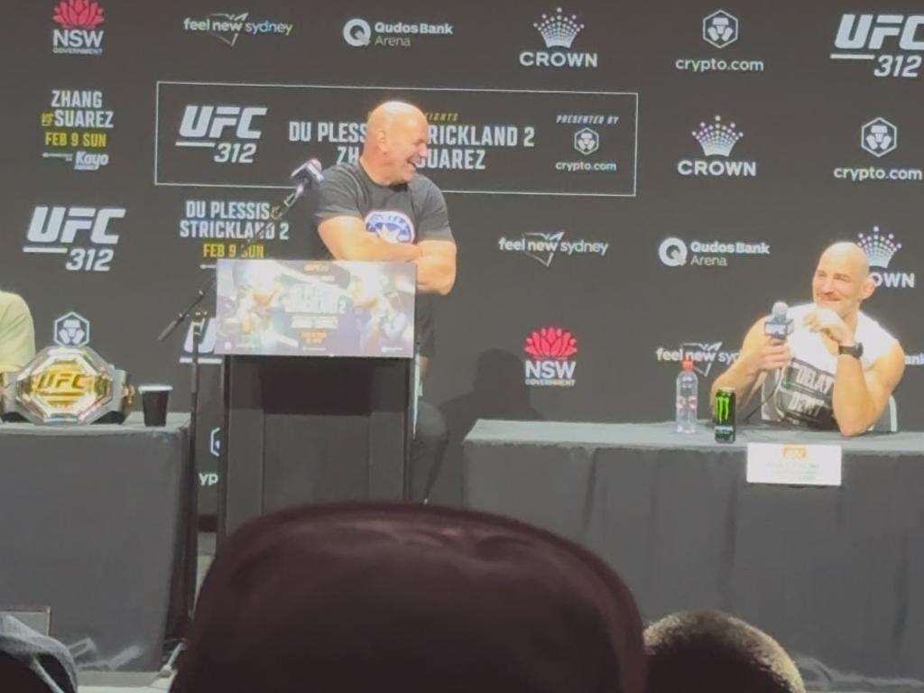 UFC boss Dana White (left) and Strickland (right) react to the image.