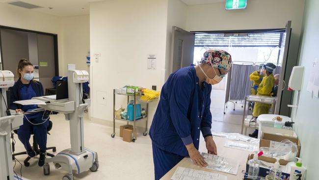 Niamh Costello and Judy Bradbury in the engine room of the clinic processing documents for patient tests. Image Matthew Vasilescu