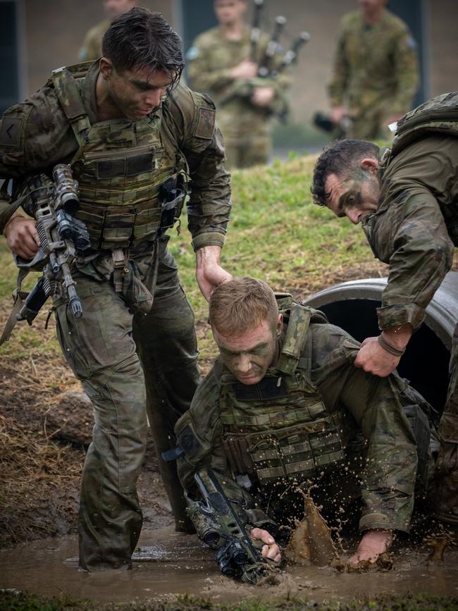 Australian Army soldiers from the 3rd Battalion, Royal Australian Regiment, assist a section member during an obstacle course activity held as part of the the Duke of Gloucester Cup at the Lone Pine Barracks in Singleton. *** Local Caption *** Australian Army infantry soldiers from across Australia tested their core skills for the prestigious Duke of Gloucester Cup at the School of Infantry, near Singleton in NSW, July 31 - August 5 2022. The Duke of Gloucester Cup is the Armyâ€™s premier military skills competition, pitting the best Royal Australian Corps of Infantry rifle sections from each unit against one another through a series of challenging activities that test their core infantry skills, including marksmanship, tactics, teamwork and fitness. Along with the Duke of Gloucester Cup, five other trophies are awarded: Sir Arthur MacDonald Trophy for best foundation war-fighting skills; Gurkha Trophy for best live-fire shooting; Royal Ulster Rifles Trophy for best falling plate shooting; OSCMAR Trophy for best battle endurance; and the DSM Roche CSC Memorial Cup for best individual soldier. The Duke of Gloucester Cup was created by Prince Henry, Duke of Gloucester, in 1946, while serving as the Governor-General of Australia.