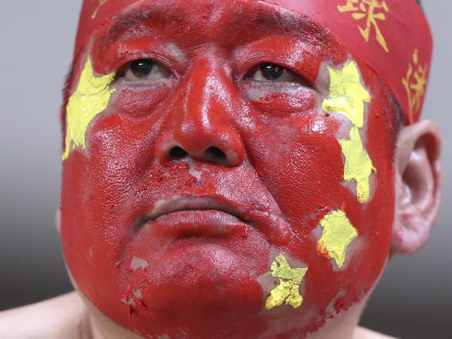 In this Thursday, Sept. 1, 2016 photo, a supporter of the China national soccer team with his face painted in the China's national color during the soccer match against South Korea for the 2018 FIFA World Cup qualifier at Seoul World Cup Stadium in Seoul, South Korea. (AP Photo/Lee Jin-man, File)