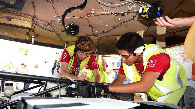 Team working on final touches of a solar/hybrid car.