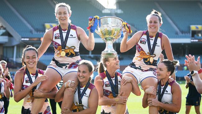 Arnell and Emma Zielke of the Lions are hoisted by their teammates after winning the 2021 AFLW Grand Final. Picture: Getty