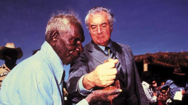 Former PM Gough Whitlam pours sand into hand of Vincent Lingiari during a 1975 ceremony marking the handover of traditional Gurindji land at Wave Hill.