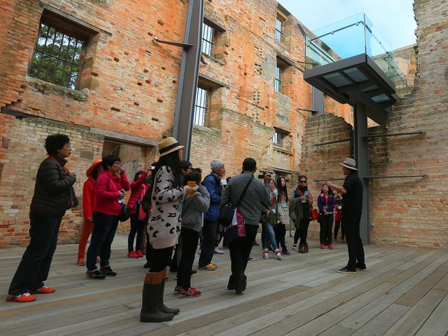 SUN TAS: PORT ARTHUR: Asian tourists being guided by Chinese speaking guides at the Port Arthur Historic Site.