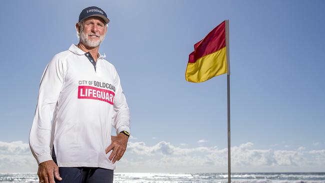 Senior City of Gold Coast Lifeguard Rob Dorrough setting up the red and yellow flags at Surfers Paradise. Picture: Jerad Williams