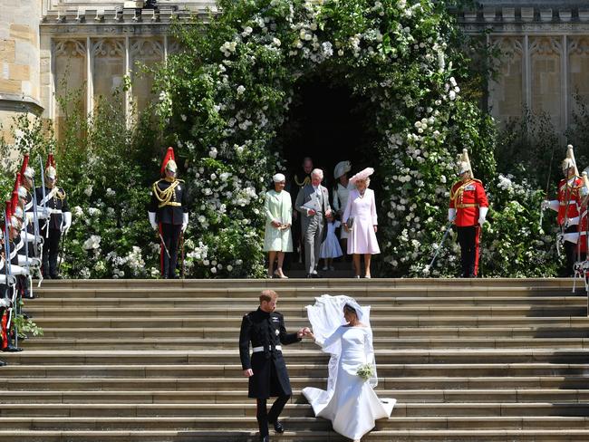 The pair walk down the chapel steps as husband and wife.