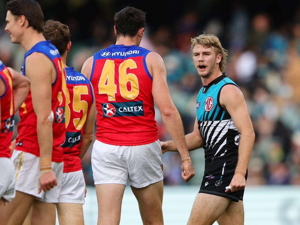 Jason Horne-Francis of the Power has words with Oscar McInerney in Round 15. Sarah Reed/AFL Photos via Getty Images.