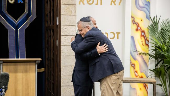 Josh Frydenberg hugs Scott Morrison at the Passover Service at the Ark Centre Synagogue in Kooyong. Picture: Jason Edward