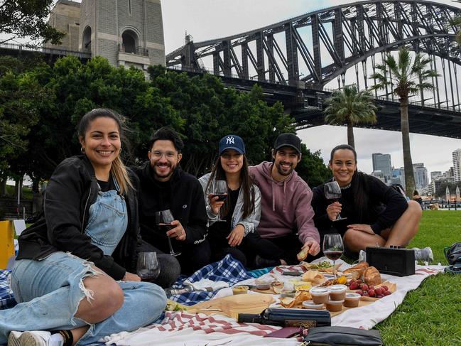 SYDNEY, AUSTRALIA - NewsWire Photos, SEPTEMBER, 25, 2021: (L-R) Coco Guerrero, Felipe Torres, Carla Felizzola, Nicholas Felizzola and Jolie Mg pose for a photograph during a picnic at Hickson Road Reserve in Sydney. Beers and bubbles will be permitted at some of Sydney's favourite public spaces as a temporary measure to reward and thank vaccinated picnickers. Picture: NCA NewsWire/Bianca De Marchi