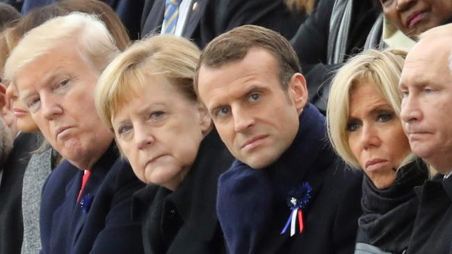 TOPSHOT - (FromL) Canadian Prime Minister Justin Trudeau, Morocco's Prince Moulay Hassan, Moroccan King Mohammed VI, US First Lady Melania Trump, US President Donald Trump, German Chancellor Angela Merkel, French President Emmanuel Macron and his wife Brigitte Macron, Russian President Vladimir Putin and Australian Governor-General Peter Cosgrove attend a ceremony at the Arc de Triomphe in Paris on November 11, 2018 as part of commemorations marking the 100th anniversary of the 11 November 1918 armistice, ending World War I. (Photo by ludovic MARIN / POOL / AFP)