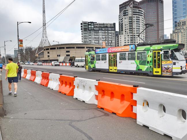 Plastic bollards along Princes Bridge to prevent pedestrians from vehicle attacks. Picture: Tony Gough