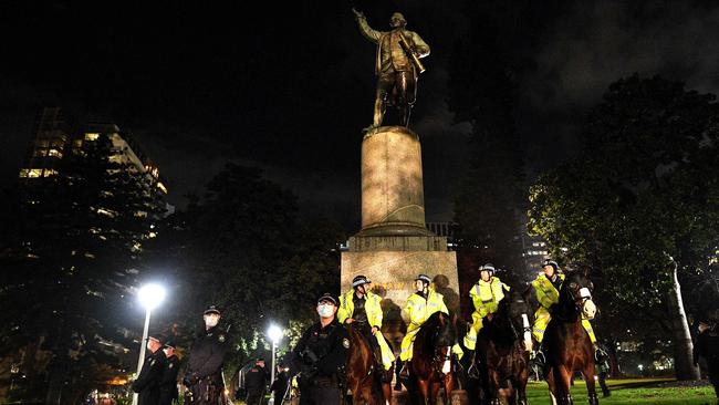 On Friday, NSW Police stood guard at the statue of Captain Cook in Hyde Park to protect it from vandalism. Picture: Saeed Khan/AFP