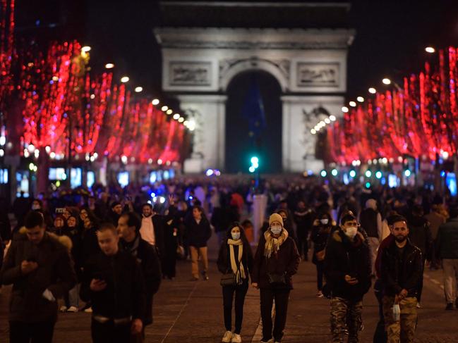 Pedestrians walk along the Champs-Elysees Avenue on New Year's Eve. Picture: AFP