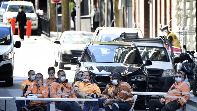 Construction workers set up an outdoor break room on the intersection of A’Beckett and Elizabeth streets. Picture: Andrew Henshaw