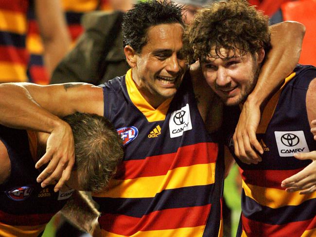 Andrew McLeod embraces Mark Ricciuto and Ken McGregor after a Crows win at AAMI Stadium. Picture: Matt Turner.