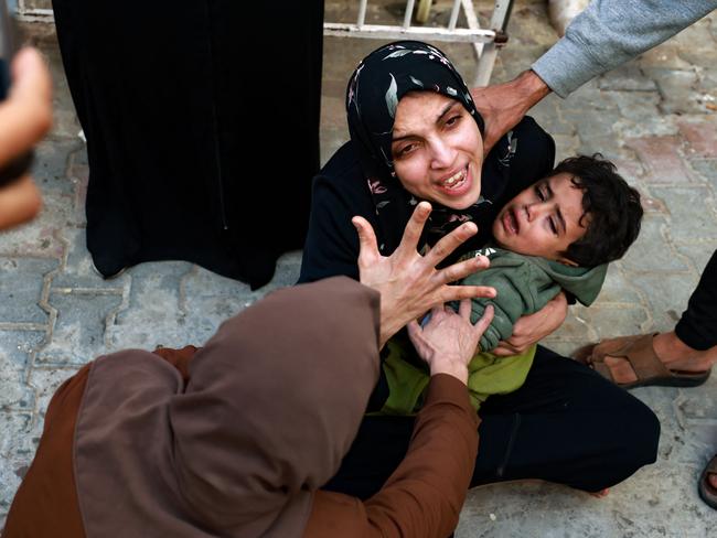 A woman holding a child mourns her baby girl killed in an Israeli strike in Rafah in the southern Gaza Strip. Picture: Mohammed Abed/AFP
