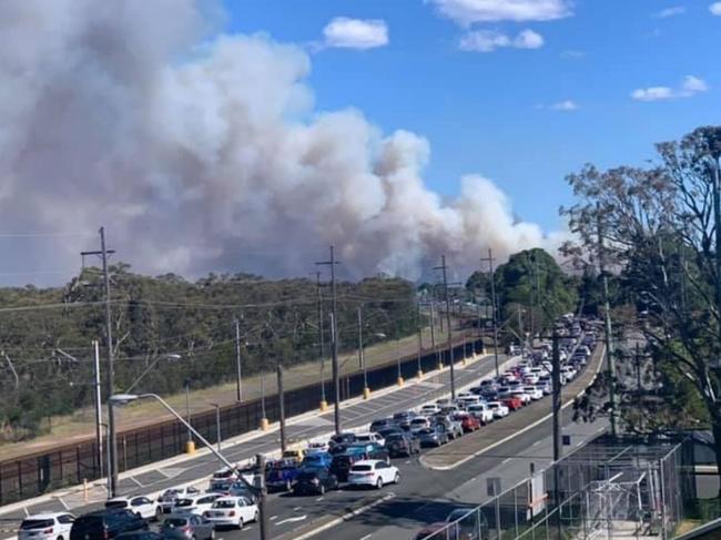 Image from NSW Rural Fire Service Facebook page."Advice: Kangaroo Ridge, Princes Hwy Waterfall (Sutherland LGA).Crews are working to contain a fire south of Heathcote in the Royal National Park. This has started after a hazard reduction to the west of the Princes Hwy has spotted, to the east of the railway line. Crews are being assisted by water bombing aircraft in an effort to control this fire. There are no current threats to property however a large amount of smoke will be visible and is affecting the Princes Hwy. Traffic will be heavily delayed  throughout the afternoon so avoid unnecessary travel in this area. "https://www.facebook.com/nswrfs/photos/a.10150499693320552/10158492221935552/