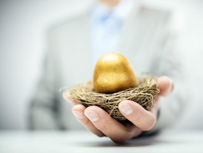 Retirement savings golden nest egg in a businessmans hand