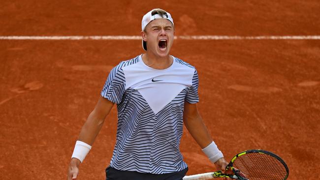 Holger Rune of Denmark celebrates winning match point against Francisco Cerundolo. (Photo by Clive Mason/Getty Images)