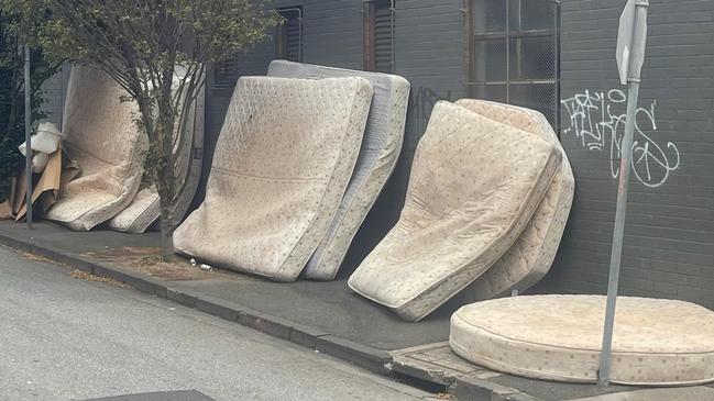 The used mattresses stacked up outside Gotham City.