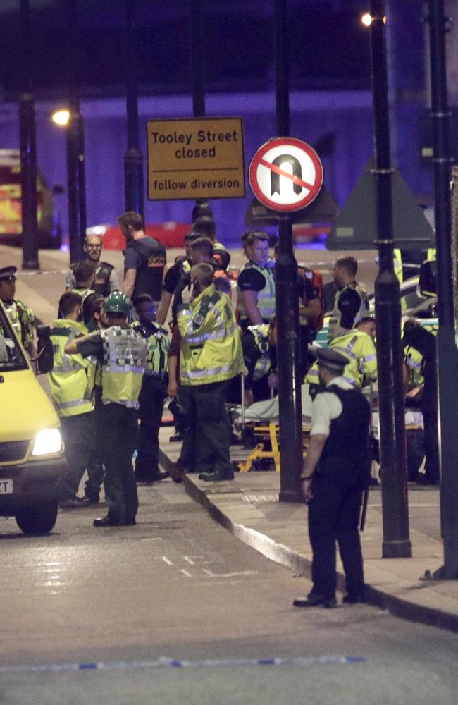 Emergency personnel tend to wounded on London Bridge. Picture: Dominic Lipinski/PA via AP