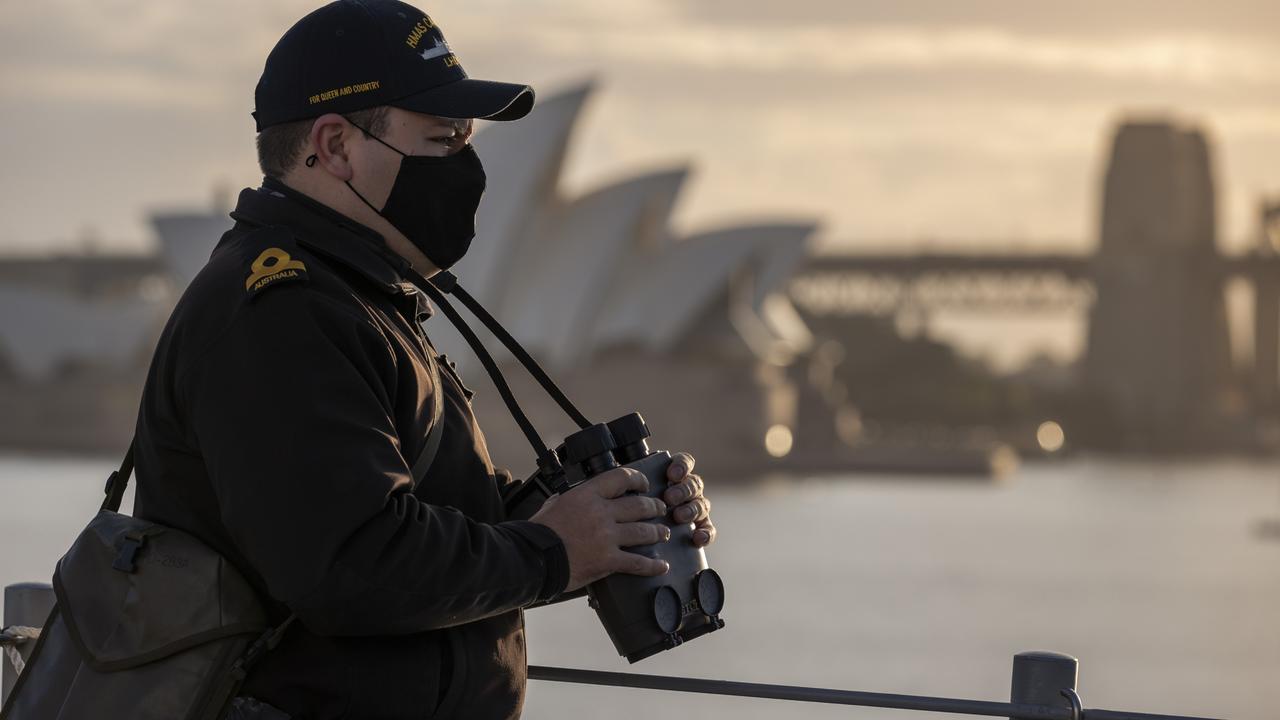 Sub Lieutenant Jaycob Humphreys looks out from the quarterdeck of HMAS Canberra as it departs Fleet Base East, in Sydney for a four-month deployment including Talisman Sabre 2021. Picture: Defence