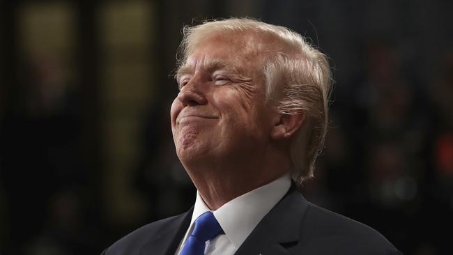 President Donald Trump smiles during State of the Union address in the House chamber of the U.S. Capitol to a joint session of Congress Tuesday, Jan. 30, 2018 in Washington. (Win McNamee/Pool via AP)