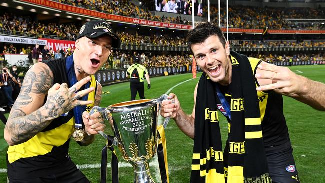 BRISBANE, AUSTRALIA - OCTOBER 24: Dustin Martin of the Tigers celebrates with the AFL Premiership Cup and captain Trent Cotchin of the Tigers after winning the 2020 AFL Grand Final match between the Richmond Tigers and the Geelong Cats at The Gabba on October 24, 2020 in Brisbane, Australia. (Photo by Quinn Rooney/Getty Images)