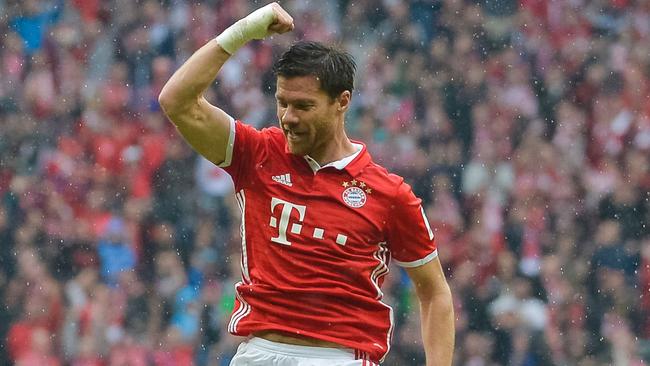 Xabi Alonso celebrates a goal for Bayern Munich.