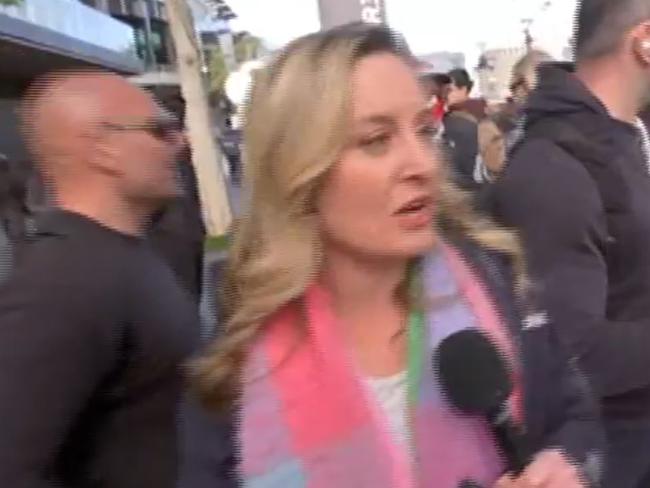 Shocking scenes have broken out for a second day outside a weapons expo in Melbourne, with a protester seen in a physical altercation with ABC security live on air. Picture: ABC 24