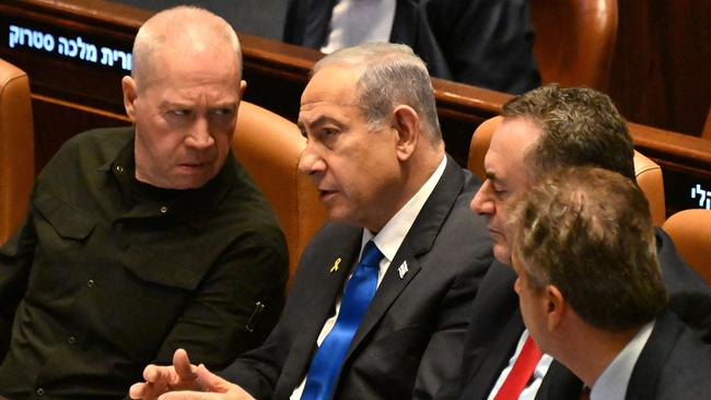 Benjamin Netanyahum centre, confer with Defence Minister Yoav Gallant, left, at the opening of the 25th Parliament session in Jerusalem on October 28. Picture: AFP