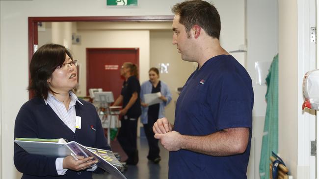 Clinical support worker Fei Song speaks with Michael Breeze at Prince of Wales Hospital. Picture: John Appleyard