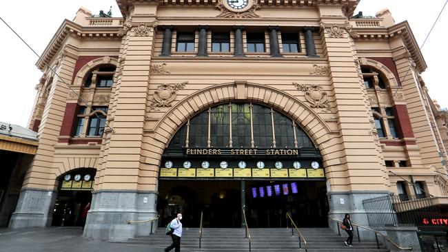 Monday morning on the steps of Melbourne’s Flinders Street Station was eerily quiet. Picture: Dave Geraghty