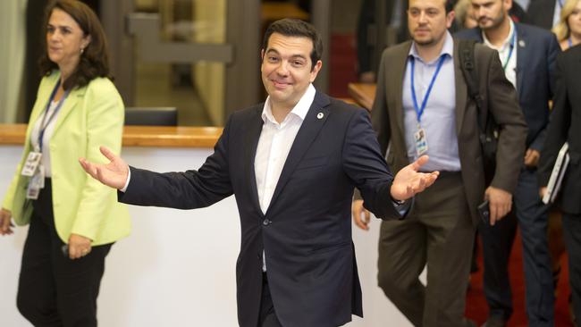 Greek Prime Minister Alexis Tsipras, center, leaves the building after an emergency summit of eurozone heads of state or government in Brussels on Tuesday, July 7, 2015. Frustrated and angered eurozone leaders gave Greek Prime Minister Alexis Tsipras a last-minute chance on Tuesday to finally come up with a viable proposal on how to save his country from financial ruin. (AP Photo/Michel Euler)