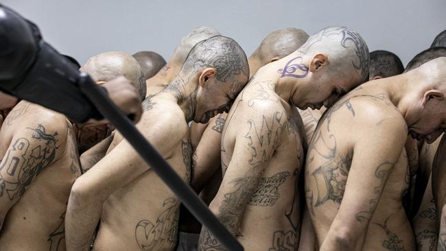 Detainees are marshalled by gun-wielding guards. (Photo by Handout/Presidencia El Salvador via Getty Images )