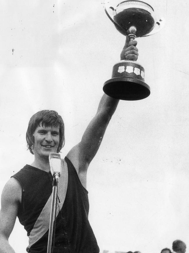 Royce Hart holding the Australian football Championship trophy after Richmond defeated Sturt at Football Park in 1974.