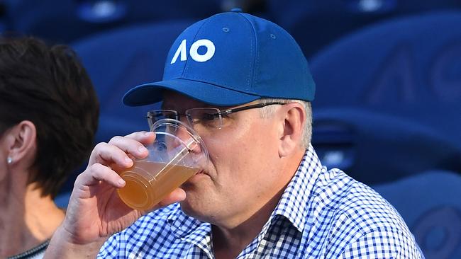 Australian Prime Minister Scott Morrison enjoys a beer during the match between Roger Federer of Switzerland and Stefanos Tsitsipas of Greece on day seven of the 2019 Australian Open tennis tournament. Picture: AAP Image/Lukas Coch