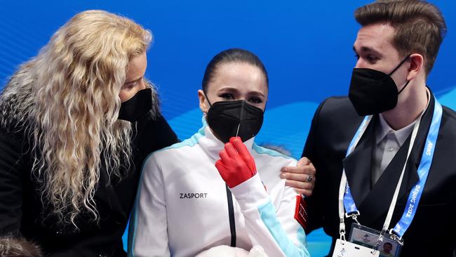 Kamila Valieva reacts to her score with choreographer Daniil Gleikhengauz (R) and coach Eteri Tutberidze. Picture: Getty Images