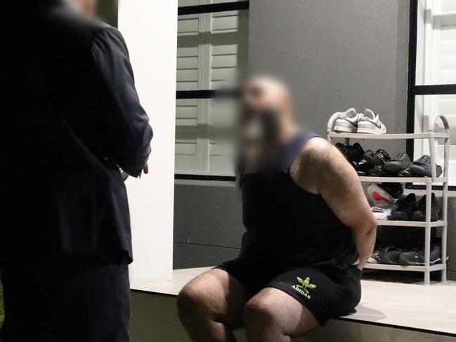 One of the men is arrested on Wednesday morning. Picture: NSW Police