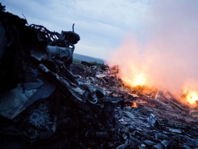 Debris from Malaysia Airlines Flight 17 is shown smouldering in a field July 17, 2014 in Grabovo, Ukraine near the Russian border.